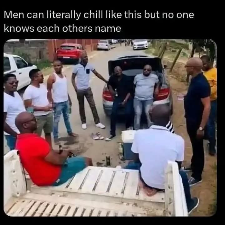 a group of men are gathered around a truck